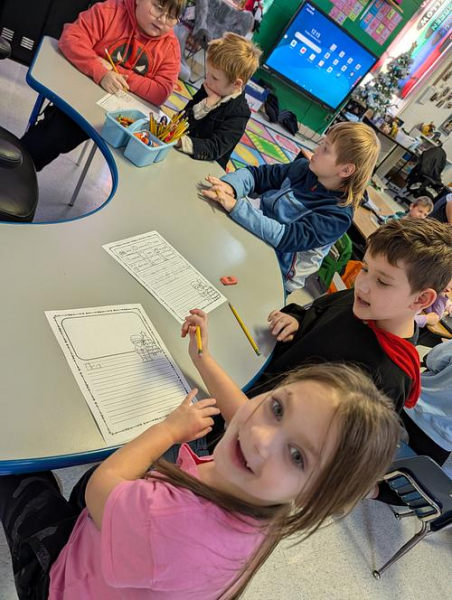 Elementary students work in a small group.